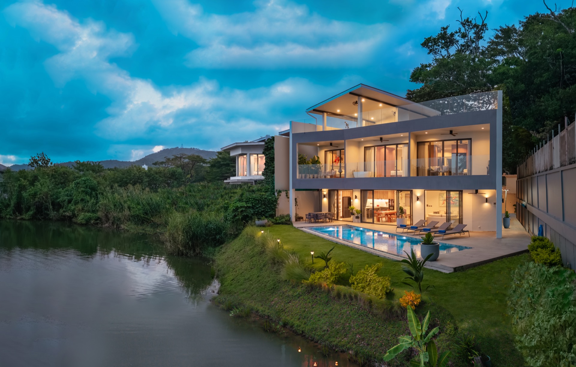 A private pool villa beside a lake in Rawai, Phuket, at dusk